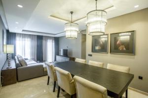 uma sala de jantar com uma mesa e cadeiras e um sofá em W-Aldorf em Casablanca