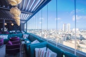 a restaurant with blue couches and a view of a city at W-Aldorf in Casablanca