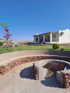 a stone bench in front of a building at Sterrenhemel Guest Farm in Upington