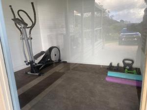 a gym with two exercise bikes and a window at Seacroft Beach House in Sugarloaf