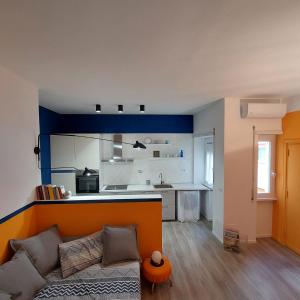 a living room with a couch and a kitchen at Vaticano & Villa Pamphilj Studio in Rome