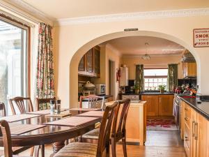 an open kitchen and dining room with a table and chairs at Byeways - Railway Carriage in Selsey