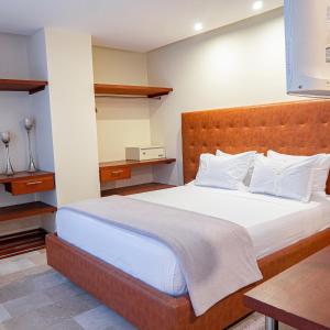 a bedroom with a large bed with white pillows at PlazaMar Pacifico Hotel in Buenaventura