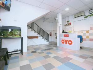 a waiting room with an oo sign on a checkered floor at KB Rest Inn-Family Triple in Kota Bharu