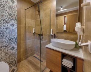 a bathroom with a sink and a shower at Hotel Sinan Han in Mostar