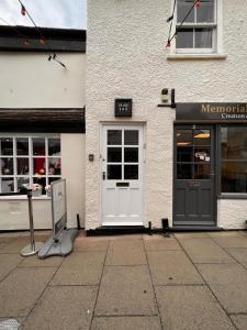 a store with a door and a sign in front of it at Historic Grade 2 listed, Town centre, St.Neots Cambridgeshire in Hail Weston +10 photos