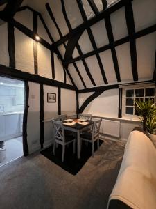 a dining room with a table and chairs in a room at Historic Grade 2 listed, Town centre, St.Neots Cambridgeshire in Hail Weston