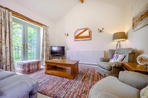 a living room with a couch and a tv at Pickle Barn in Lupton