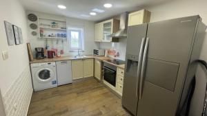 a kitchen with a refrigerator and a washer and dryer at Istrian stone Villa Lenny near Porec in Poreč