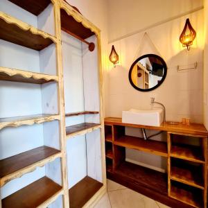a bathroom with a sink and a mirror at Pousada Doce Mar in Guarda do Embaú +155 photos