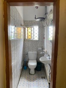 a bathroom with a toilet and a sink at Apex guest facility in Buea
