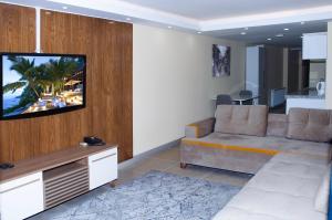 a living room with a couch and a flat screen tv at Berlin Hotel Nisantasi in Istanbul