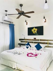 a bedroom with a bed with flowers on it at Rangali Etos Guraidhoo in Guraidhoo