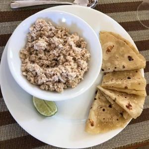 a plate with a bowl of oatmeal and two tortilla chips at Rangali Etos Guraidhoo in Guraidhoo