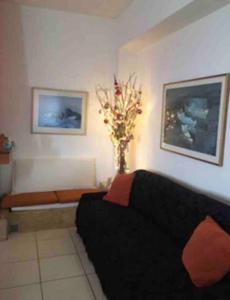 a living room with a black couch and a vase of flowers at Sea view luxury apartment in Aiándion