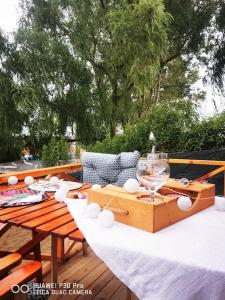 a table with a wine glass on top of it at İstanbul AirPort Bungalow in Arnavutköy