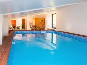 a swimming pool with blue water in a house at May Cottage-uk38279 in Cloughton