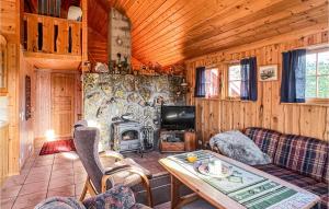 a living room with a couch and a stove at Awesome Home In Hovden I Setesdalen With 2 Bedrooms in Hovden