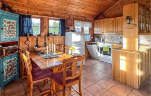 a kitchen with a table and a refrigerator at Cozy Home In Hovden I Setesdalen With Kitchen in Hovden