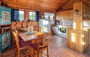 a kitchen with a table and a refrigerator at Awesome Home In Hovden I Setesdalen With 2 Bedrooms in Hovden