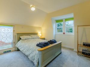 a bedroom with a bed and two windows at Vine Cottage in Broadstairs