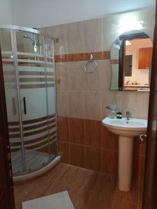 a bathroom with a shower and a sink at Arianna in Paleokastritsa