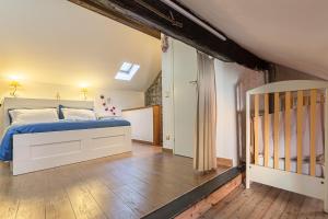 a bedroom with a bed and a crib at Casa al Lago di Como in Riva Cernobbio in Cernobbio