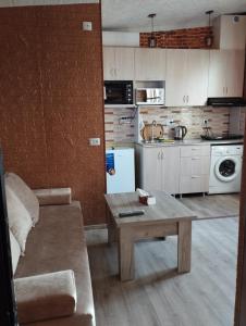 a kitchen with a couch and a table in a room at COZY HOTEL SKS in Yerevan