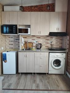 a kitchen with a sink and a washing machine at COZY HOTEL SKS in Yerevan