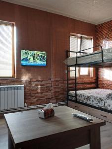 een kamer met 2 stapelbedden en een tafel bij COZY HOTEL SKS in Jerevan