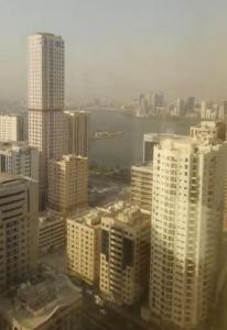 a view of a city with tall buildings at Sharjah Rose Tower in Sharjah
