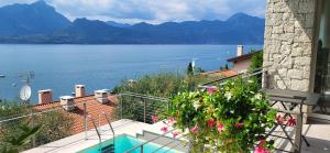 a house with a balcony with a view of the water at IL SOGNO 1 Piscina e vista lago in Torri del Benaco