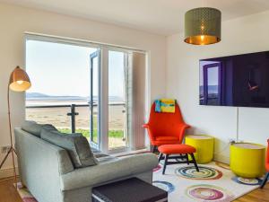 a living room with a view of the beach at Bayview in Llanelli