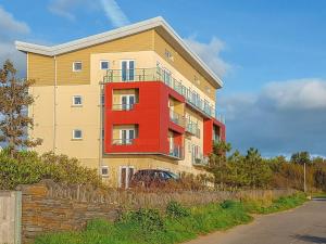 a tall building with a red and yellow at Bayview in Llanelli