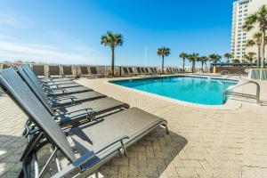 - une rangée de chaises longues à côté de la piscine dans l'établissement Ocean Villa 1303, à Panama City Beach