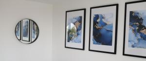 a group of framed photographs on a wall at Wolverhampton - Gated Parking - George House in Wolverhampton