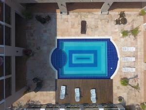 an overhead view of a swimming pool with a tennis racket at MANSION BOHEMIA in Búzios