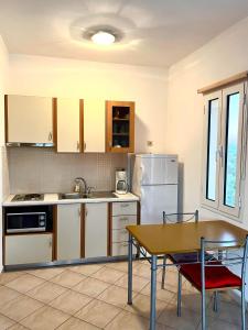 a kitchen with a table and a table and chairs at Emmanouil in Kythira