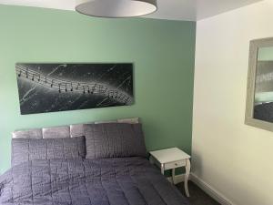 a bedroom with a bed and a picture of a bridge at Nirvana house, 3 bedroom, 3 level riverside location in Deepcar
