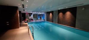 a large swimming pool in a building with at Orbi Palace Deluxe Bakuriani Room 406 in Bakuriani