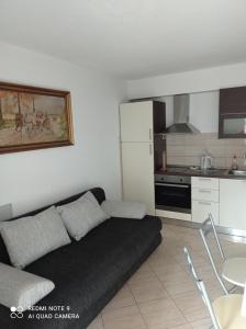 a living room with a couch and a kitchen at House Vida Goraleks in Baška Voda +27 photos
