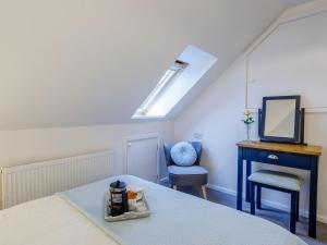 a bedroom with a bed and a desk and a chair at Vineyards Apartment in Ely