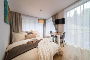 Postel nebo postele na pokoji v ubytování Rákosárna Suites & Apartments