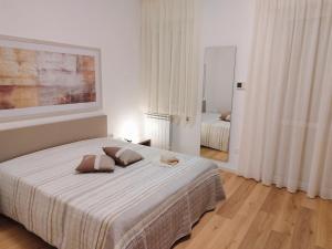 a bedroom with a bed with two pillows on it at Alcamo Rooms con garage privato in Alcamo