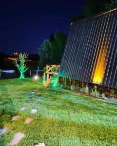 a building with lights in the yard at night at İstanbul AirPort Bungalow in Arnavutköy