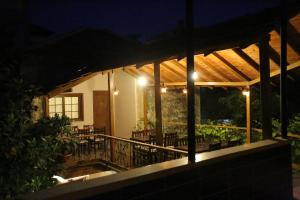 a patio with tables and chairs at night at Osmanli Marco Pasha Hotel in Tarsus