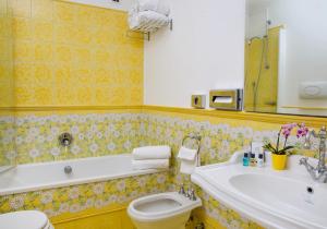 a bathroom with a tub and a toilet and a sink at Relais Maresca Luxury Small Hotel & Terrace Restaurant in Capri