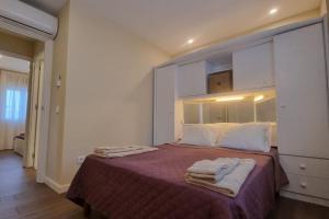 a bedroom with a large bed with towels on it at Casinha da Belavista in Arcos de Valdevez