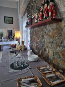 a table in a room with a stone wall at HOTEL "ZAUŁEK" Spółka Cywilna Zbigniew Świderski, Elżbieta Świderska in Lubań