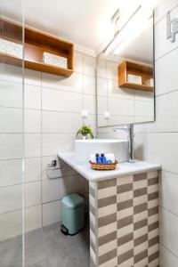 W łazience znajduje się umywalka i lustro. w obiekcie Rikki Apartment w Korfu
